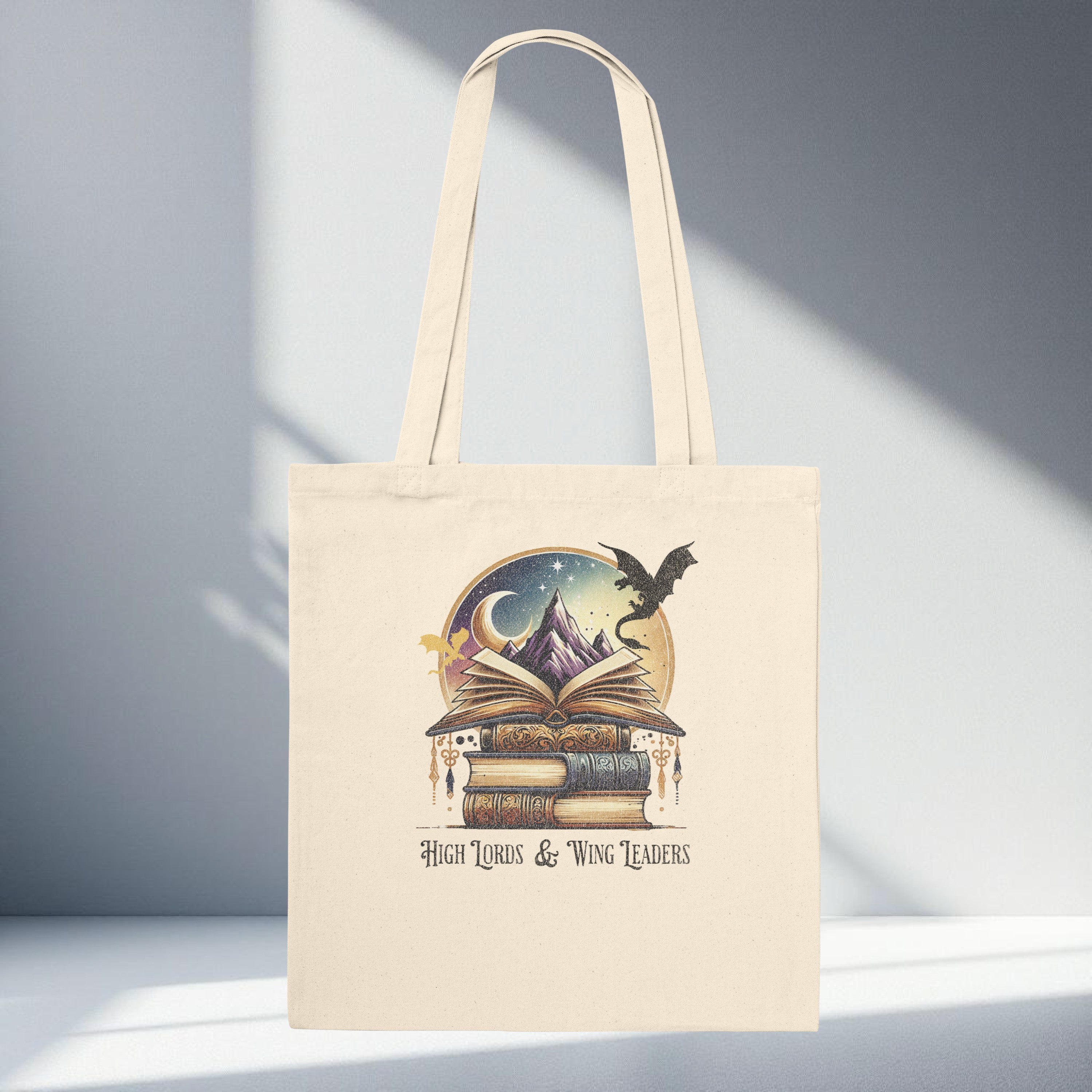 Fantasy book dragon tote bag with stacked books, open book, mountain, moon and dragon silhouette design on neutral canvas, romantasy reader aesthetic tote bag.