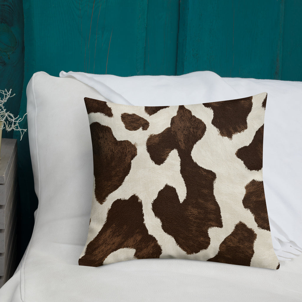 Cow print decorative cushion styled on a chair.