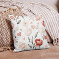 Floral decorative cushion with soft neutral tones.