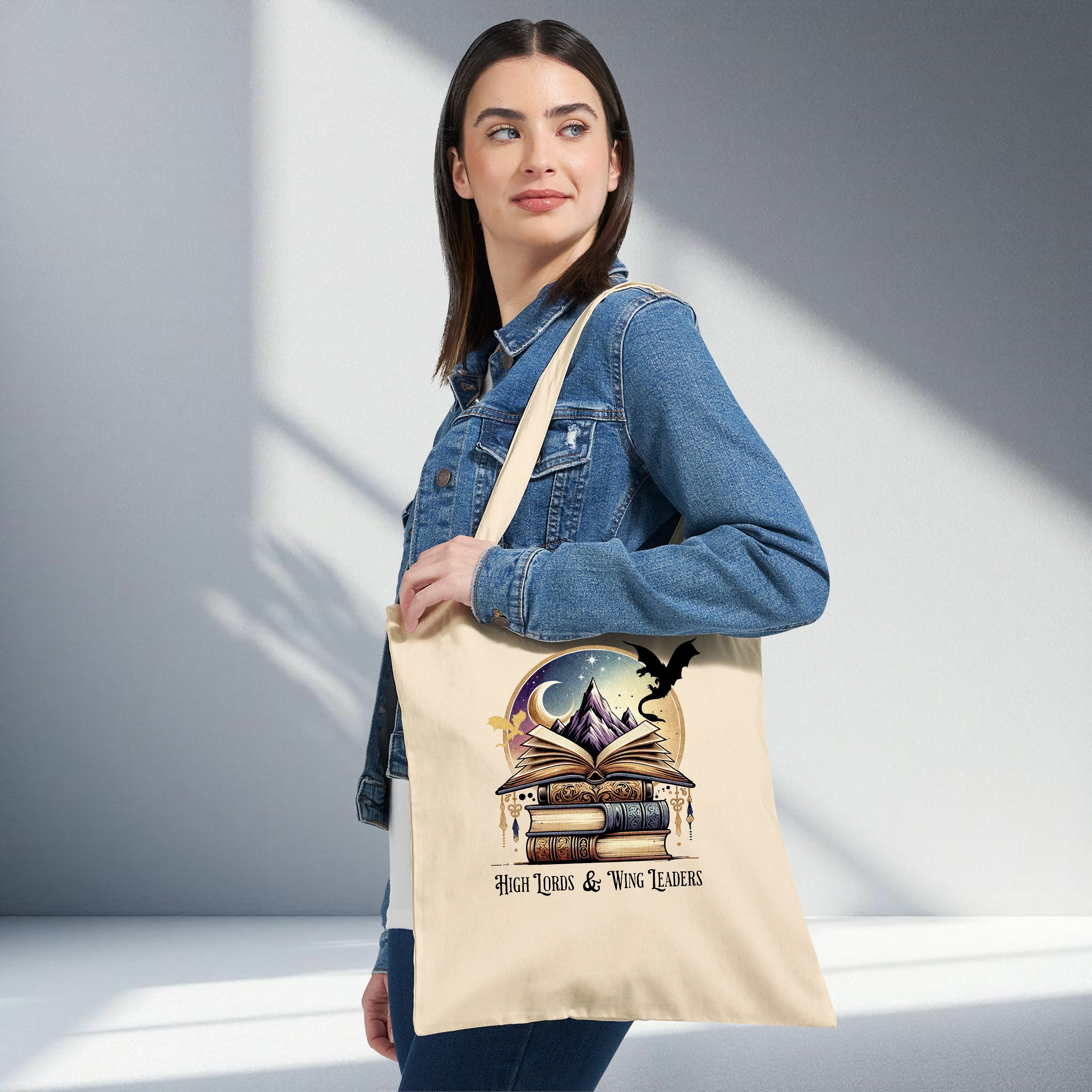 Fantasy book dragon tote bag with stacked books, open book, mountain, moon and dragon silhouette design on neutral canvas, romantasy reader aesthetic tote bag.