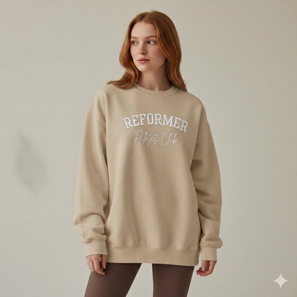 Reformer Pilates Club embroidered sweatshirt in sand beige worn by model oversized Pilates jumper wellness aesthetic