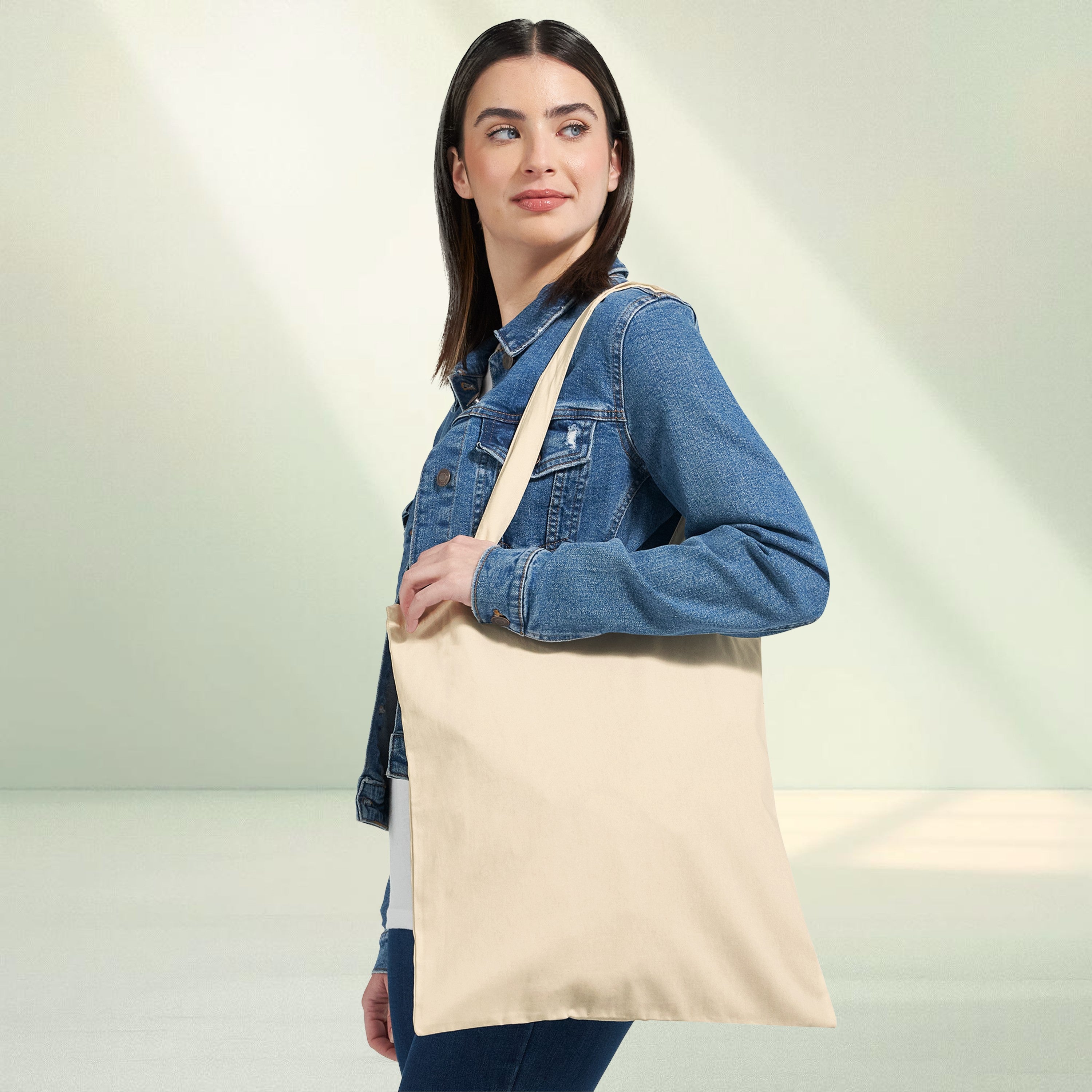 Neutral canvas tote bag featuring a circular fantasy illustration of a dragon flying alongside a rider surrounded by stylised clouds and sky tones, with romantasy themed quote text around the design.